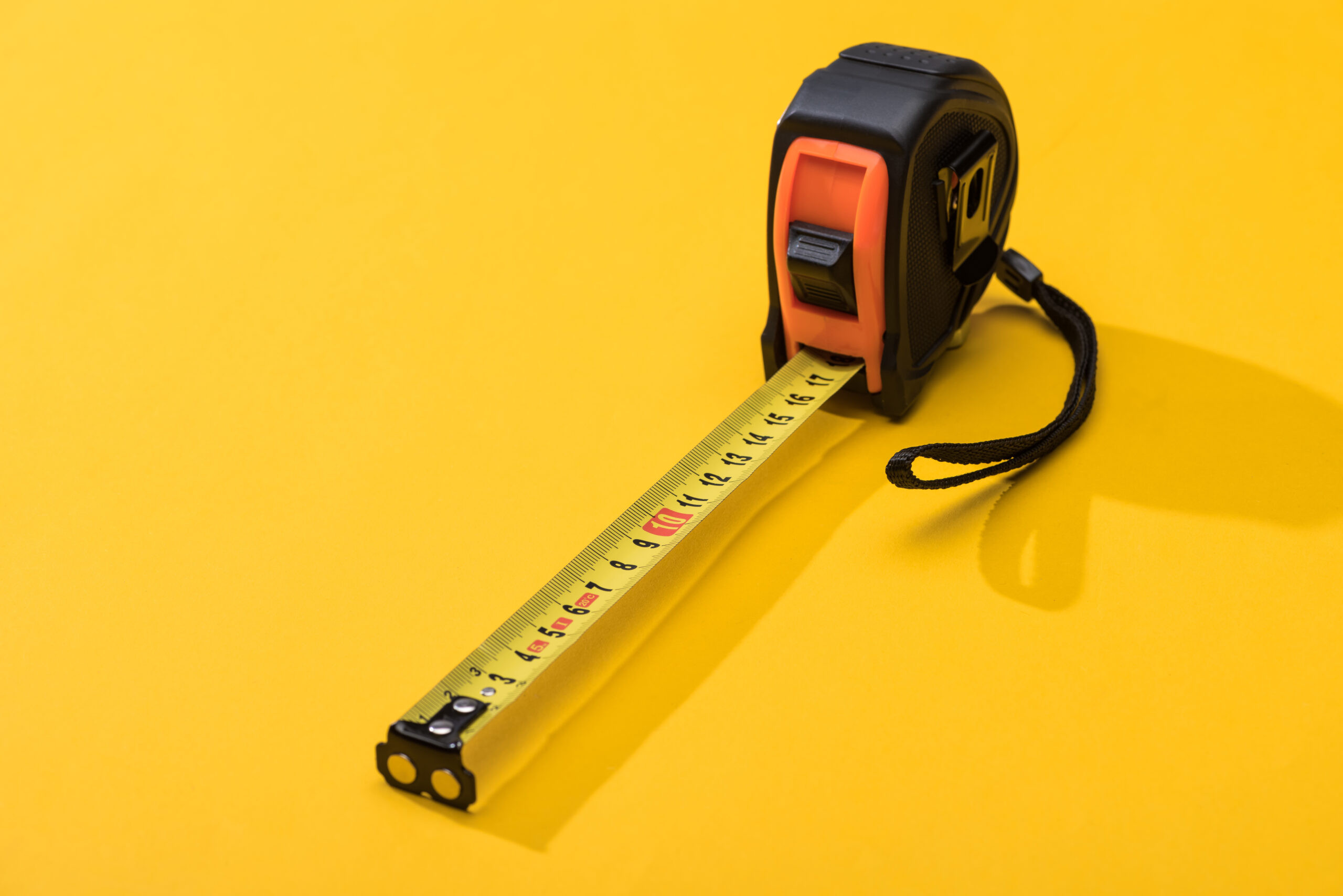 measuring tape on yellow background