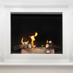 White marble fireplace in modern interior with flame burning